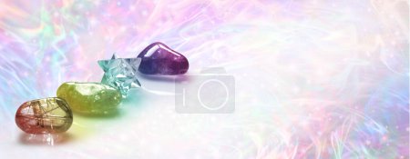 Photo for Crystal Healing web banner background template - three tumbled crystals and a merkabah against a multicoloured wispy energy field background with copy space for message or business card text - Royalty Free Image
