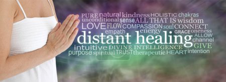 Lightworker sending distant healing - mature female in white dress with hands in prayer position beside a DISTANT HEALING word cloud on a murky energy field background