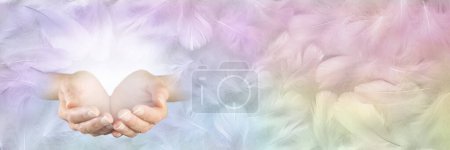 Healer with Angelic Energy Banner - Female cupped hands and white light against wide multicoloured feather background ideal for a spiritual theme gift certficate, invitation or advert
