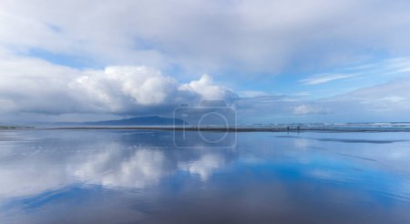 Photo for White clouds reflecting in the ocean during a low tide on the Oregon Coast. - Royalty Free Image