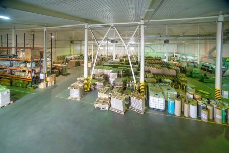Big production warehouse with paper rolls and printing material