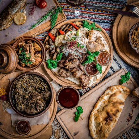 Photo for Arabic Cuisine: Middle Eastern traditional lunch. It's also Ramadan "Iftar". The meal eaten by Muslims after sunset during Ramadan. Assorted of Arabic oriental dishes. top view with close up. - Royalty Free Image