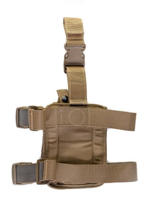 Holster hanging on soldier's leg. Leg holder for gun. Isolated military tactical