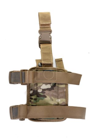 Holster hanging on soldier's leg. Leg holder for gun. Isolated military tactical