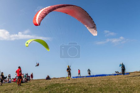 Photo for A view of a paraglider practicing extreme sport in Trzesacz in Poland circa August 2021 in Trzesacz. - Royalty Free Image