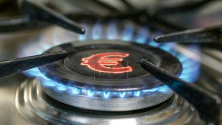 Téléchargez les photos : Brûleur à gaz et signe Euro, symbole monétaire européen sur la cuisinière à gaz domestique. Concept de crise énergétique. Concentration sélective. - en image libre de droit
