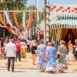 Seville, Spain - April 26, 2023 : People taking a walk and enjoying at the Seville's April Fair.