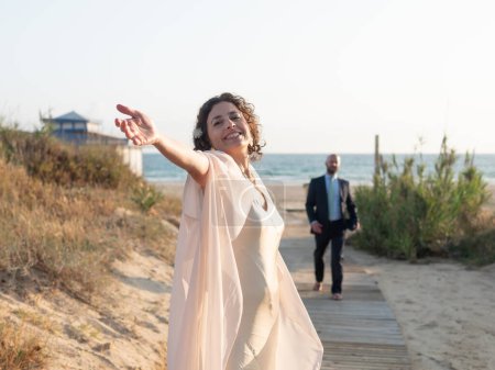 Joyful Newlyweds Celebrating on Beach at Sunset