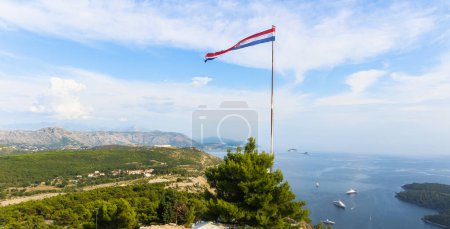 Photo for Step into the enchanting world of Dubrovnik Majesty, where every frame tells a story of panoramic splendor. From the top, embrace the rolling hills, majestic mountains, serene seasides, and the embrace of a brilliant blue sky. The Croatian flag waves - Royalty Free Image