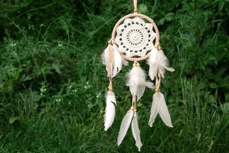 Beautiful dreamcatcher, american native shaman amulet in summer forest