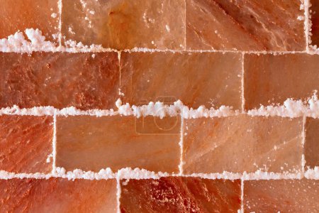 Photo for Himalayan pink salt textured wall in spa or sauna room - Royalty Free Image
