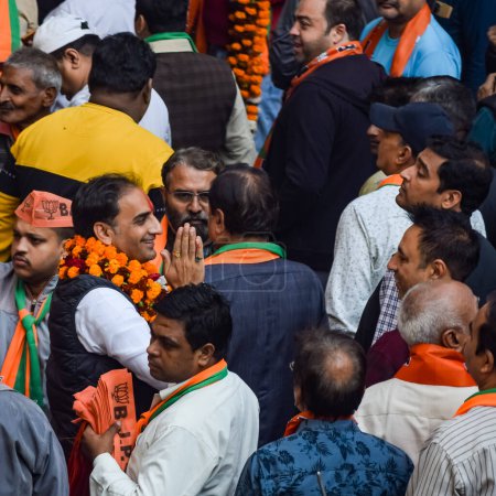 Photo for New Delhi, India, November 20 2022 - Bharatiya Janata Party (BJP) supporters during a rally in support of BJP candidate Pankaj Luthara to file nomination papers ahead of MCD local body Elections 2022 - Royalty Free Image