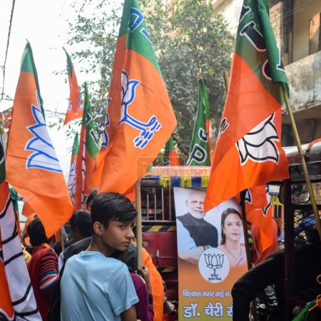 Photo for Delhi, India, December 02 2022 -Bharatiya Janata Party (BJP) supporter during mega road show in support of BJP candidate Pankaj Luthara to file nomination papers ahead of MCD local body Elections 2022 - Royalty Free Image