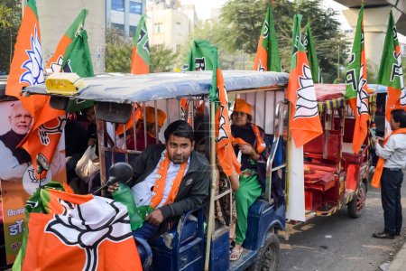 Photo for Delhi, India, December 02 2022 -Bharatiya Janata Party (BJP) supporter during mega road show in support of BJP candidate Pankaj Luthara to file nomination papers ahead of MCD local body Elections 2022 - Royalty Free Image