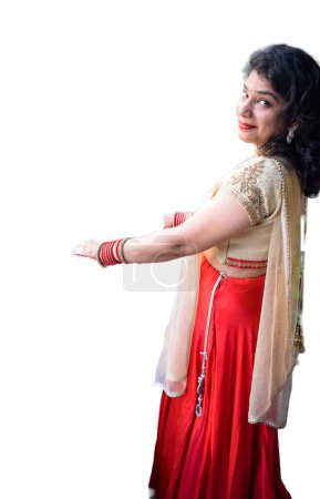 Photo for Beautiful woman dressed up as Indian tradition with henna mehndi design on her both hands to celebrate big festival of Karwa Chauth with plain white background - Royalty Free Image