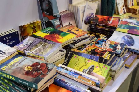Photo for New Delhi, India, February 17 2024 - Variety of Books on shelf inside a book-stall at Delhi International Book Fair, Selection of books on display in Annual Book Fair at Bharat Mandapam complex - Royalty Free Image