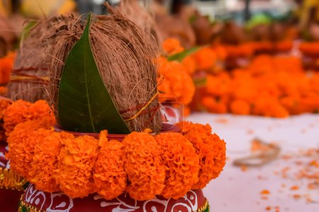 Kalash with coconut and mango leaf with floral decoration earthen pots containing sacred water. Kalash for hindu puja during Jagannath Temple Mangal Kalash Yatra, front view, closeup