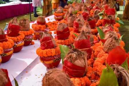 Photo for Kalash with coconut and mango leaf with floral decoration earthen pots containing sacred water. Kalash for hindu puja during Jagannath Temple Mangal Kalash Yatra, front view, closeup - Royalty Free Image