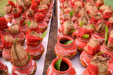 Photo for Kalash with coconut and mango leaf with floral decoration earthen pots containing sacred water. Kalash for hindu puja during Jagannath Temple Mangal Kalash Yatra, front view, closeup - Royalty Free Image