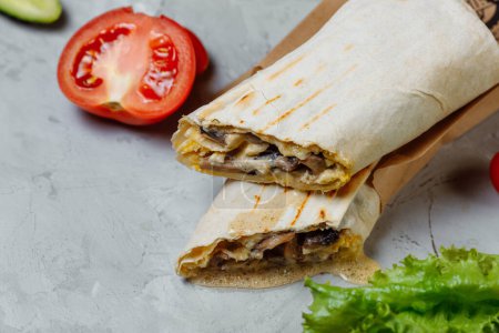 Photo for Shawarma sandwich gyro fresh roll of lavash pita bread chicken beef shawarma falafel RecipeTin Eatsfilled with grilled meat, mushrooms, cheese. Traditional Middle Eastern snack - Royalty Free Image