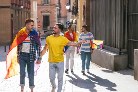 Photo for In a sun-kissed city, two gay couples radiate pure happiness, proudly adorned with LGBT symbols while holding hands, immersed in a lively sunset walk. - Royalty Free Image