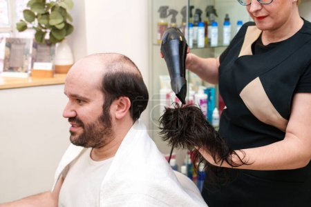Photo for Technician finishing hairpiece drying before placement. - Royalty Free Image