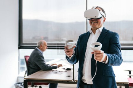 A businessman in a suit uses a VR headset and controllers, actively engaging with virtual reality in a modern office.