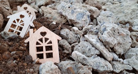 Foto de Small wooden houses on the ground and stones,earthquake concept 2023. Copy space - Imagen libre de derechos