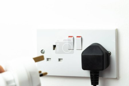 Photo for Close up of english socket in the wall, electricity bills - Royalty Free Image
