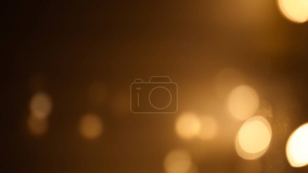 Rich brown-golden bokeh background, evoking warmth and elegance, perfect for adding depth and sophistication to designs.