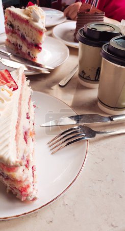 Delicious cream cakes on a cafe table, perfect for a morning breakfast treat in a cozy setting. High quality photo