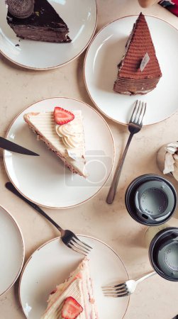 Delicious cream cakes on a cafe table, perfect for a morning breakfast treat in a cozy setting. High quality photo