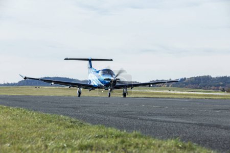 Photo for PRIBRAM, CZECH REPUBLIC - 9 NOVEMBER 2023. A modern Pilatus PC-12 NG turboprop aircraft takes off from a small airport. A blue Pilatus PC-12 NG airplane is taxiing on the runway of the airport. - Royalty Free Image