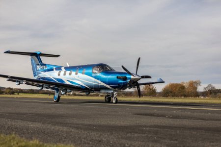 Photo for PRIBRAM, CZECH REPUBLIC - 9 NOVEMBER 2023. A modern Pilatus PC-12 NG turboprop aircraft takes off from a small airport. A blue Pilatus PC-12 NG airplane is taxiing on the runway of the airport. - Royalty Free Image