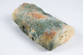 Mold on bread on a white background close-up. The danger of mold, stale products mug #628093744