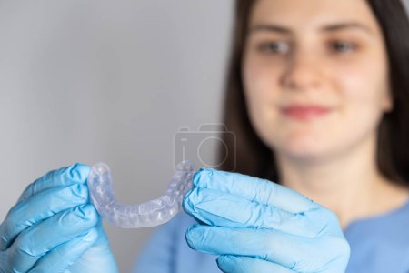 Doctor holding dental mouthguard, splint for the treatment of dysfunction of the temporomandibular joints, bruxism, malocclusion, to relax the muscles of the jaw