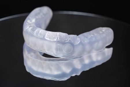 Photo for Dental mouthguard, splint for the treatment of dysfunction of the temporomandibular joints, bruxism, malocclusion, to relax the muscles of the jaw - Royalty Free Image