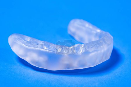 Photo for Dental mouthguard, splint for the treatment of dysfunction of the temporomandibular joints, bruxism, malocclusion, to relax the muscles of the jaw - Royalty Free Image
