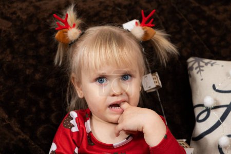 Photo for Portrait of a two-year-old blonde girl at Christmas. - Royalty Free Image