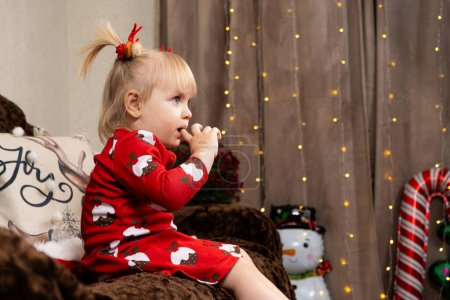 Photo for Portrait of a two-year-old blonde girl at Christmas. - Royalty Free Image