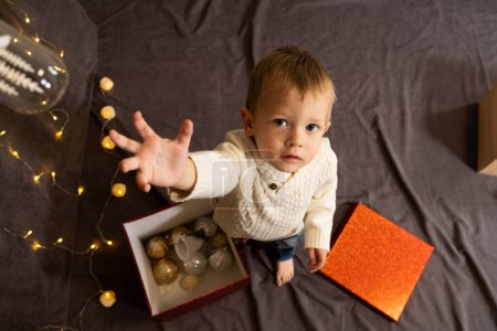 Photo for Portrait of happy little child playing with christmas toys - Royalty Free Image