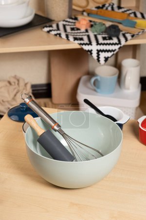 Photo for Dough kneading bowl with rolling pin and whisk on kitchen table - Royalty Free Image
