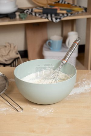 Photo for Dough kneading bowl and whisk on kitchen table - Royalty Free Image