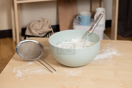 Photo for Dough kneading bowl and whisk on kitchen table - Royalty Free Image