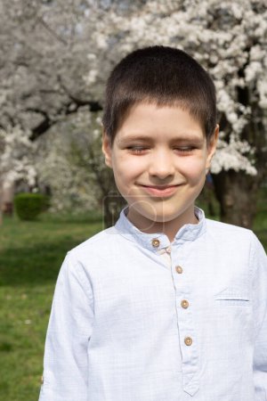 Six-year-old boy squinting in bright afternoon sun
