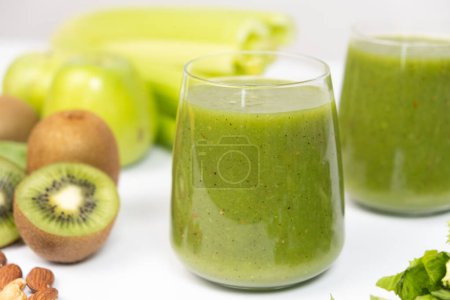 Healthy vegetable smoothie in glasses on white background