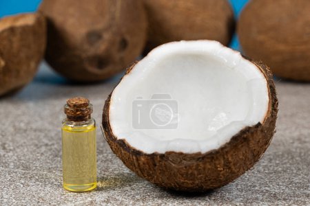 Photo for Coconut oil in a small glass bottle for skin and hair care - Royalty Free Image
