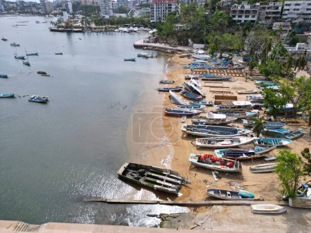 Photo for Lateral drone view showing the side of Manzanillo Beach with hurricane-damaged yachts and surroundings - Royalty Free Image