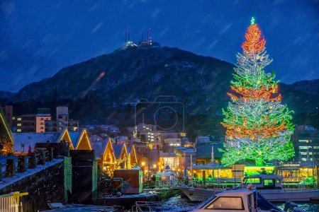 Photo for Cityscape of the historic red brick warehouses and Mount Hakodate  at twilight in Hakodate, Hokkaido Japan in winter - Royalty Free Image