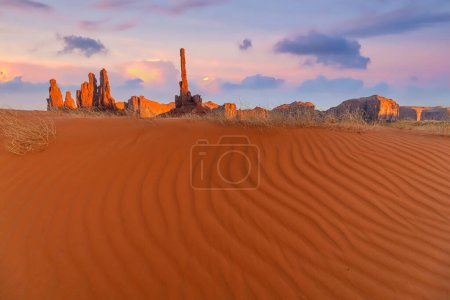 Photo for Totem pole and sand dunes  in Monument Valley, Arizona USA at sunset - Royalty Free Image